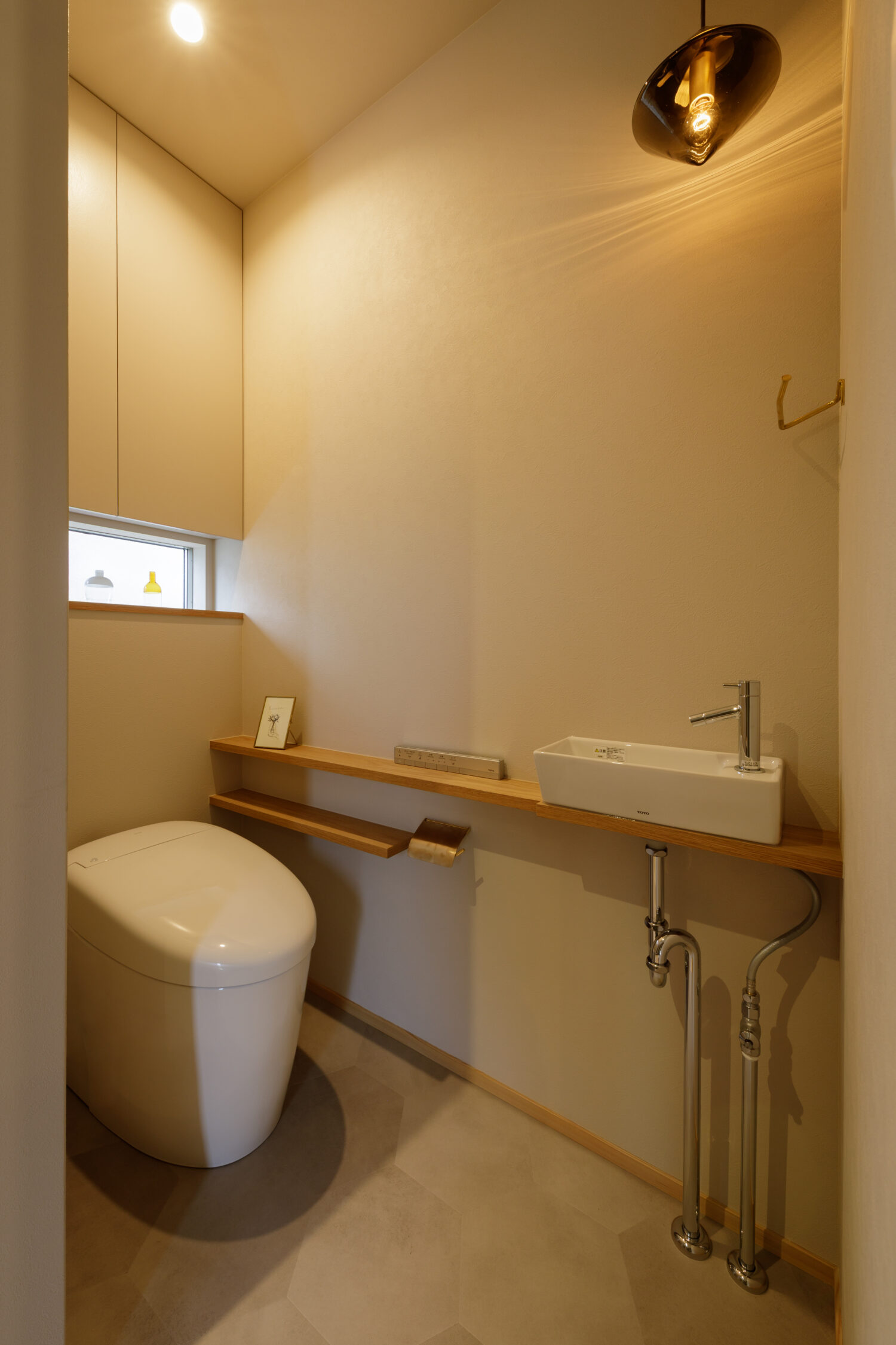 奈良市・新築注文住宅。ニューライトポタリーのペンダントライトが映える清潔感あるトイレ空間